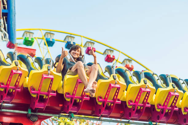 istock Beautiful, young man having fun at an amusement park 1181591527