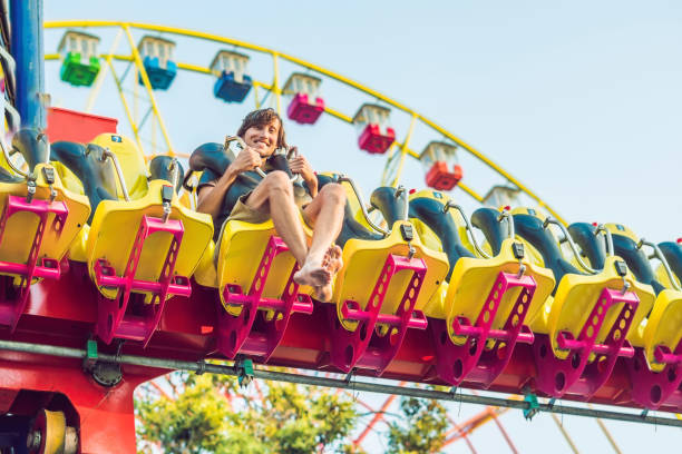istock Beautiful, young man having fun at an amusement park 1181591643