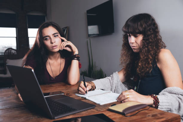 istock Women at home studying and checking financial bills 1181592754