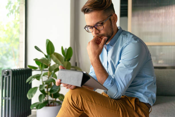 istock Young smiling Man typing on digital tablet 1181592888