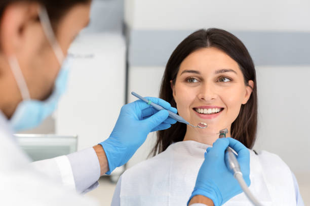 istock Smiling woman looking at dentist with trust 1181592894