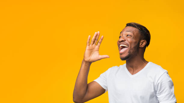 istock Black Man Shouting Holding Hand Near Mouth Standing In Studio 1181592960