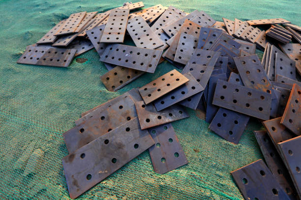 steel plates with holes stacked together\