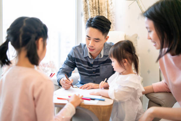 istock Asian family using crayons to draw at home 1181593474