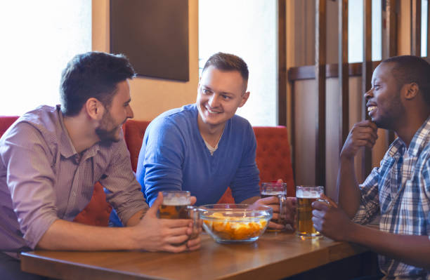 istock Three young guys having good time at bar 1181593545