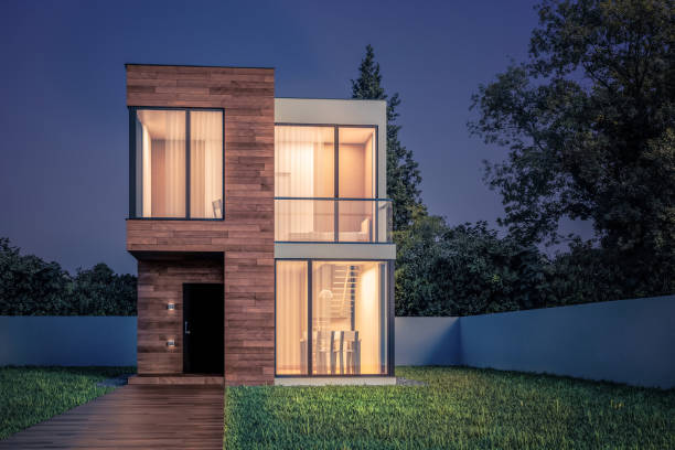 Exterior modern small square house with wooden planks at night with glowing windows 3D illustration View the exterior of a modern small house with a facade finish of hexagonal ceramic panels in the evening. 3D illustration tiny house stock pictures, royalty-free photos & images