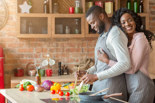 istock Grateful wife embracing her husband from behind at kitchen 1181594207
