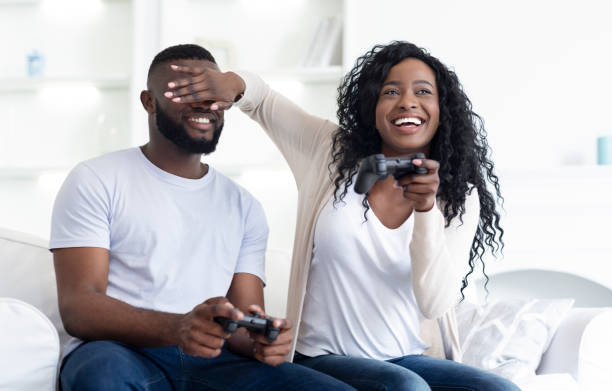 istock Millennial couple playing videogames sitting on couch at home. 1181595710