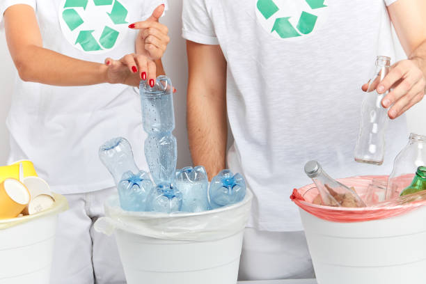 istock volunteers put the items that can be recycled into the correct bins 1181598068
