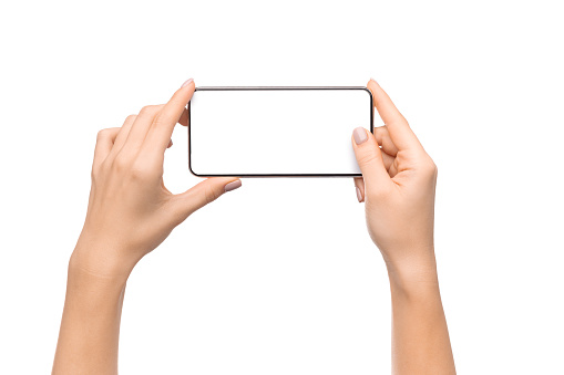 Female hands holding smartphone with blank screen taking photo, isolated on white background, free space