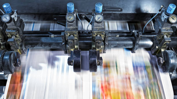 istock Newspaper sheet being cut into pages by the machine 1181598188