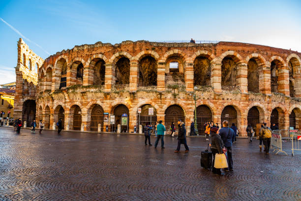 Verona-Italy Verona,Veneto,Italy 6 January 2014:Tourists in Piazza Bra in front of the Arena. Some people are walking outside the arena verona opera stock pictures, royalty-free photos & images