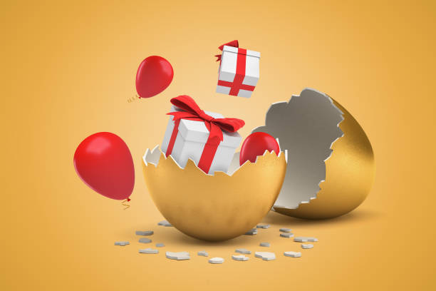 istock 3d rendering of broken golden egg, and two giftboxes and thee balloons that just hatched out from egg and are flying around. 1181600411