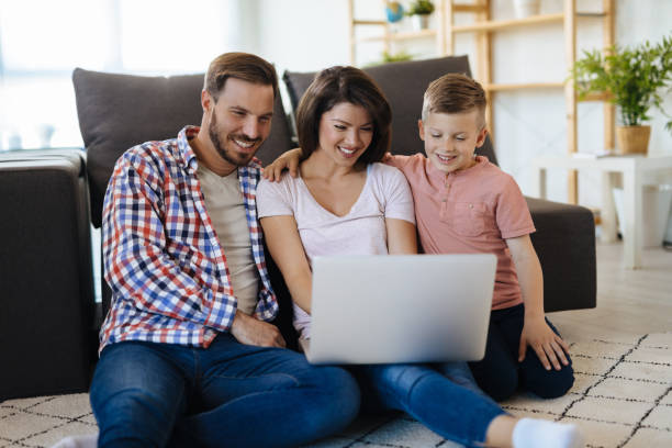 istock Happy family with little boy enjoying using laptop computer 1181600536