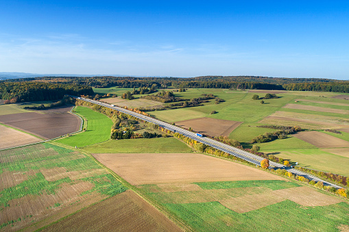 Highway through agricultural fields - aerial view