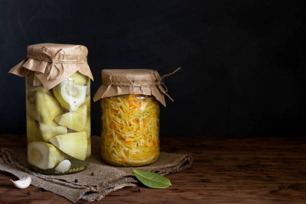 istock Sauerkraut and pickled squash in jars on a dark background 1181600631