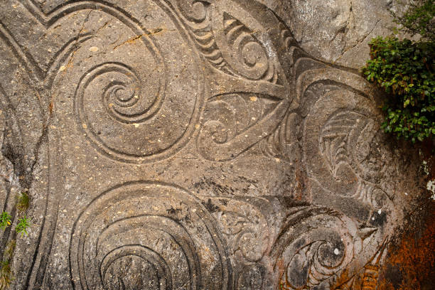 Lake Taupo, New Zealand, September 10, 2017: View from a boat of the Mine Bay Maori Rock Carvings, created by master carver Matahi Whakataka-Brightwell