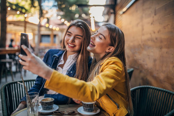 istock Young ladies taking a selfie in cafe 1181601488