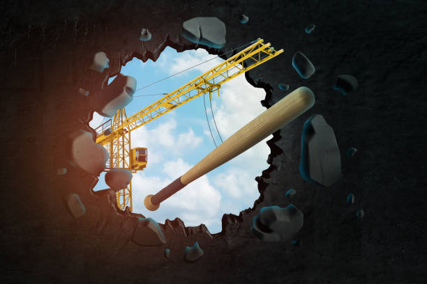istock 3d rendering of construction crane and baseball bat breaking black wall 1181603078