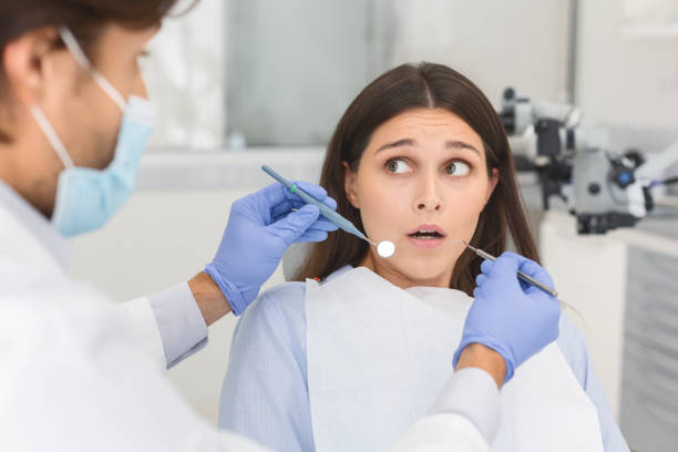 istock Scared woman looking at dentist before treatment 1181603385