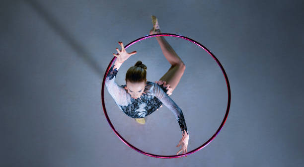 gymnast performing with hoop - the splits ethnic women exercising imagens e fotografias de stock