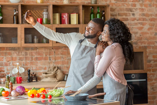 istock Happily married couple taking selfie on smartphone in kitchen 1181604559