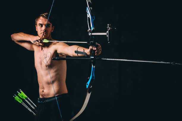 istock Man archer aiming with a bow and arrow 1181604868