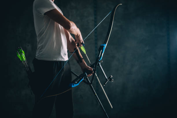 istock Man holding a bow and arrow in studio 1181604962