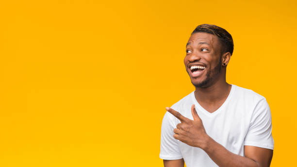 istock Excited Afro Man Pointing Finger Aside, Studio Shot, Panorama 1181607198