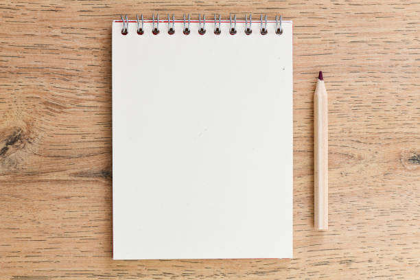 istock Office desk table with blank notebook. Top view with copy space, flat lay. 1181607349