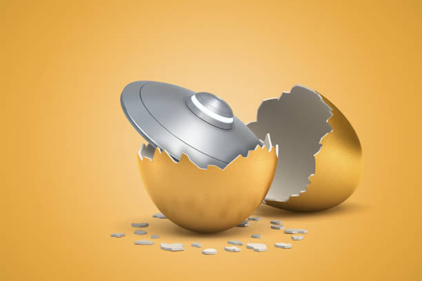istock 3d rendering of light-grey shiny flying saucer that just hatched out from golden egg. 1181607512
