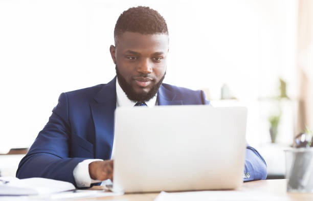 istock Concentrated young businessman working in office with laptop 1181607825