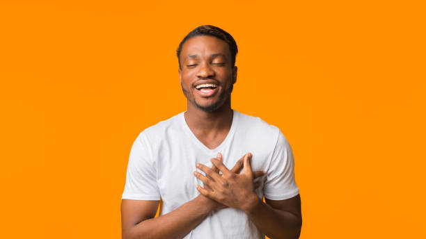 istock Afro Guy Holding Hands On Chest Standing In Studio, Panorama 1181608053