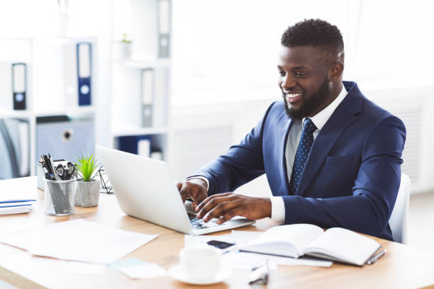 istock Happy young businessman working with laptop in office 1181608888