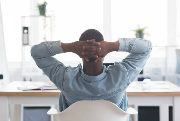 istock African american worker resting at workplace, leaning back on chair 1181608903