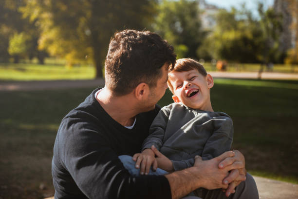 istock Father and son sitting on a skate ramp and having fun 1181609071