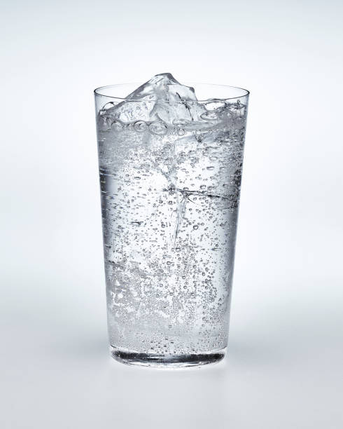 Glass of carbonated water with ice Carbonated water and ice in a thin cup soda stock pictures, royalty-free photos & images