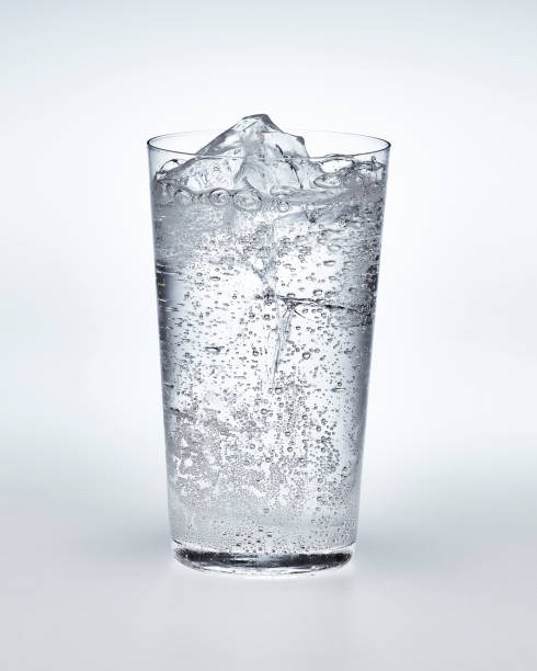 Glass of carbonated water with ice Carbonated water and ice in a thin cup carbonated drink stock pictures, royalty-free photos & images