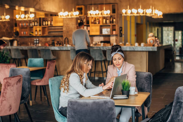 istock Two women sitting in cafe 1181611271