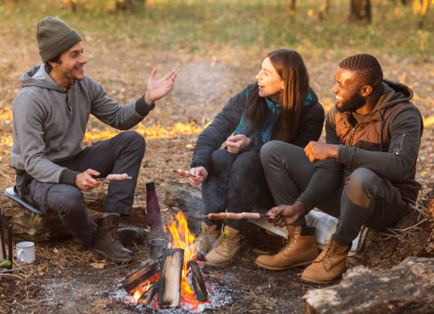 istock Friends sitting beside fireplace, enjoying time together 1181611274