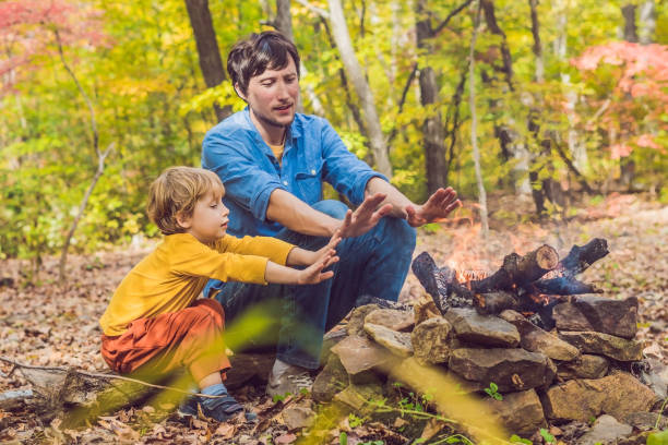 istock Happy father doing barbecue with his son on an autumn day 1181611382