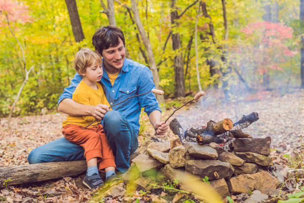 istock Happy father doing barbecue with his son on an autumn day 1181611402