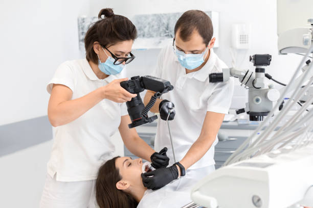 Professional dentist taking photo of patient teeth Snapping the result. Female dentist taking photo with professional camera of patient teeth, copy space teeth photos stock pictures, royalty-free photos & images