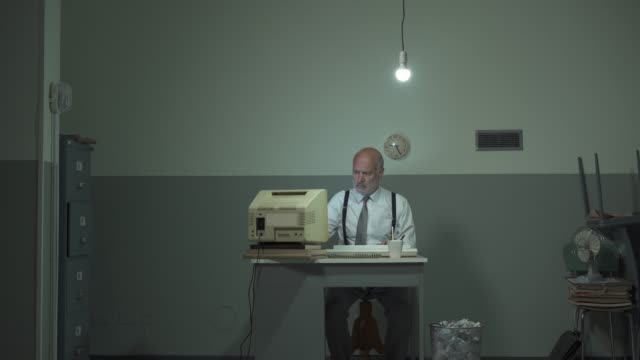 Corporate businessman hitting his outdated computer