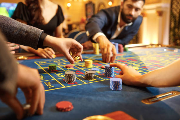 istock Hands with chips at poker roulette table gambling in a casino. 1181611543