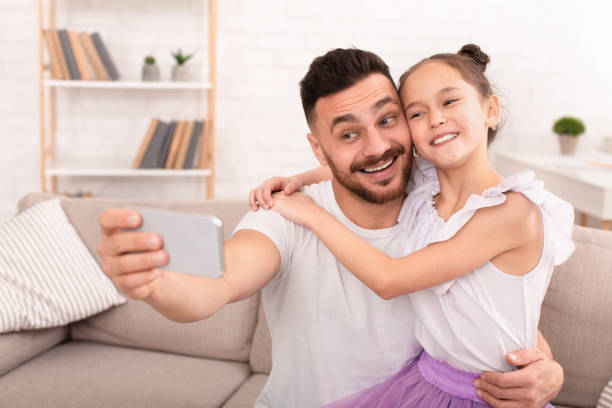 istock Happy father and child making selfie on cellphone 1181612571