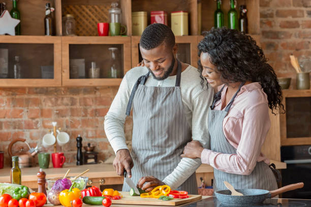 istock Cheerful black couple cooking dinner together in kitchen 1181614392