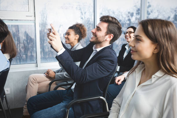istock Business man filming lecture on smartphone camera 1181616674