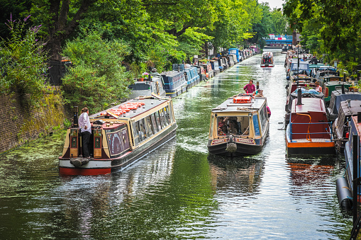 London, UK - 10 July, 2019 - Tourist water bus travelling along the Regents Canal around Little Venice