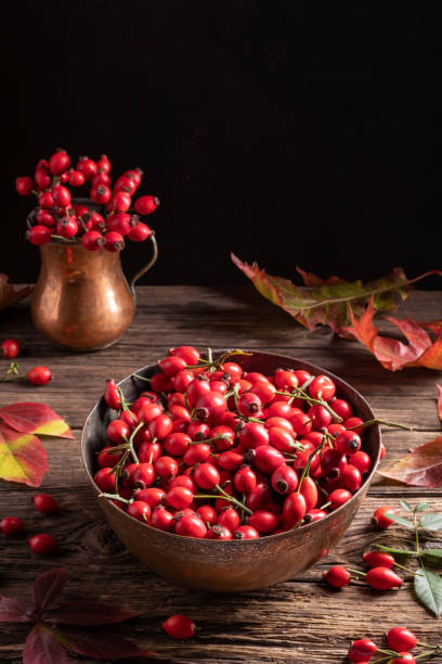 istock Rose hips in a bowl with autumn leaves 1181618433